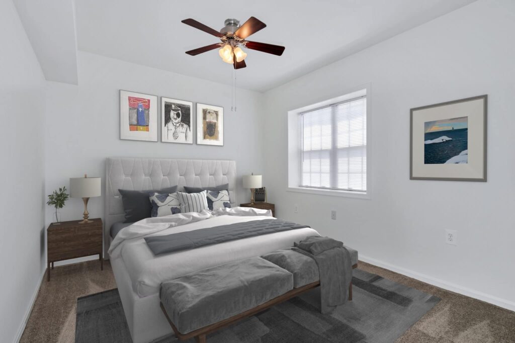 A furnished bedroom with a bed and a ceiling fan in Culpeper. | Spark Living