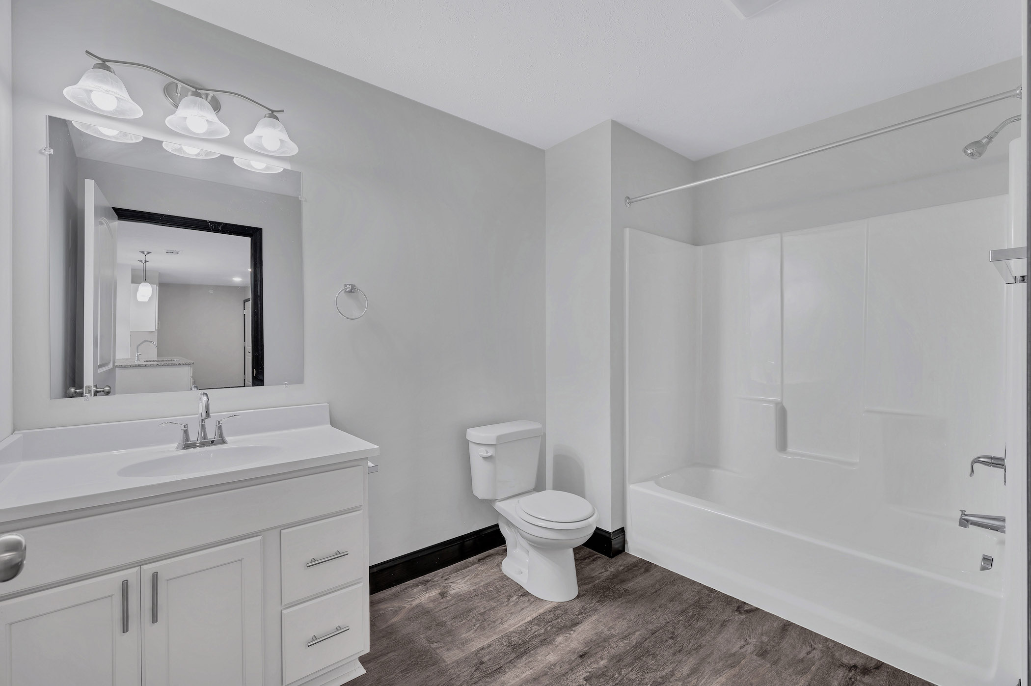 White Bathroom with Wood Floors | Spark Black Bear Apartments